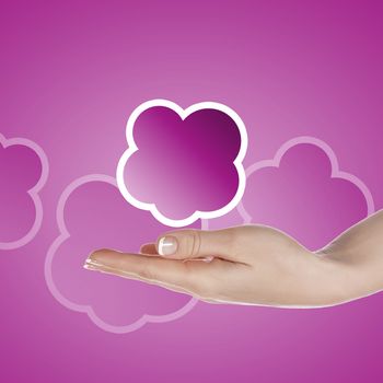 Hand with cloud computing symbol against colour background