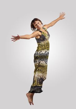 pretty modern slim hip-hop style woman jumping dancing on a grey background