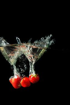 Colored red paprika in water splashes on black background