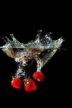 Colored red paprika in water splashes on black background