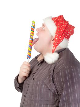 Cheerful obese man in a red Santa hat chewing on a long colourful spiral lollipop with a grin on his face isolated on white