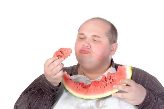 Fat man savouring a slice of watermelon holding a chunk in his hand and looking at it with satisfaction and relish isolated on white