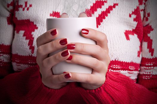 Closup of a Woman holding a hot coffee mug