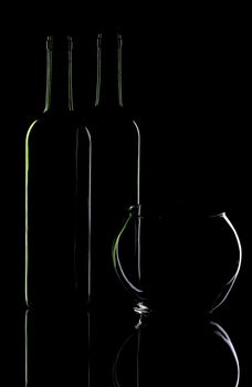 Wine bottle and glass vase on a black background