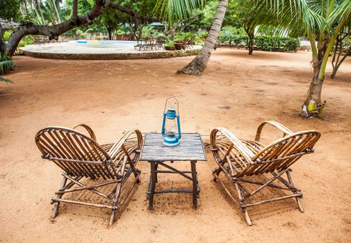 Kenya. Elegant furniture made of wood in an African garden
