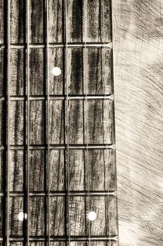Guitar neck fingerboard on textured background, close up view
