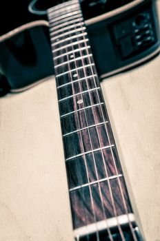 Acoustic guitar detail close up view of neck and strings