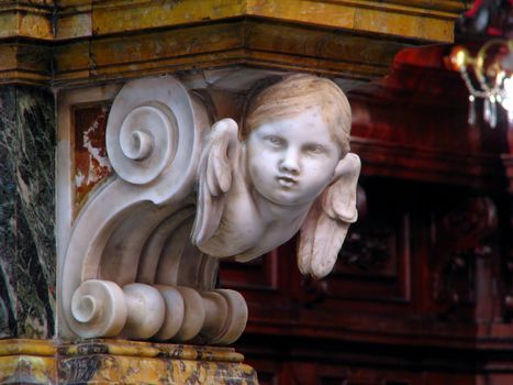 A marble angel fixed to the main altar of the church in Zebbug, Malta.