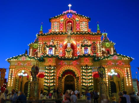 The facade of the parish church of Siggiewi in Malta brightly lit on the feast of Saint Nicholas.