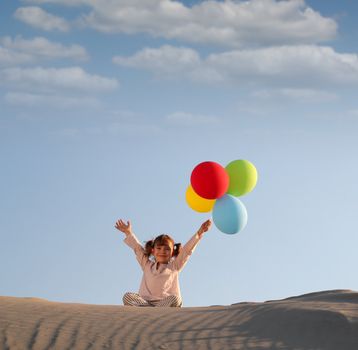 happy little girl with colorful balloons