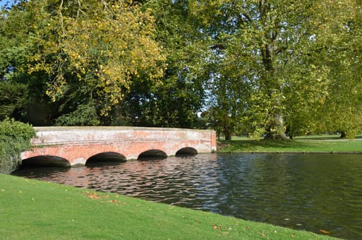 Red brick bridge in formal garden