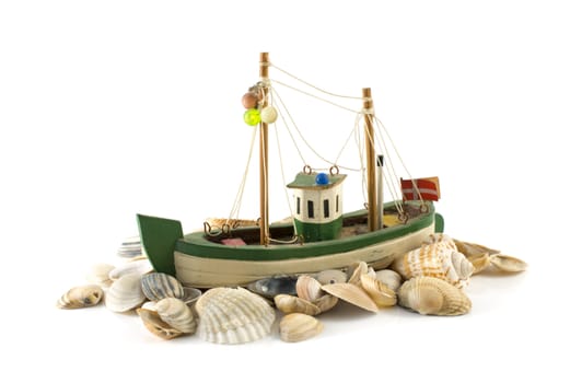 old danish model fish boatand beach shell isolated on white
