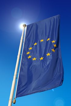 Vertical European Union flag, waving in the blue sky
