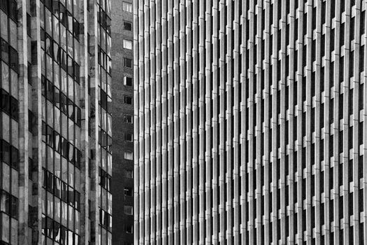 A black and white abstract shot of three buildings.