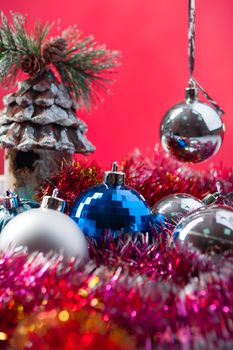 Christmas toys and balls on the red background