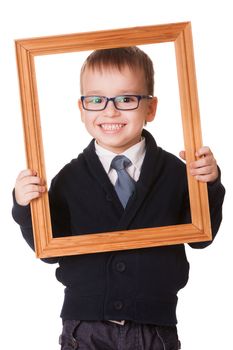 Smiling caucasian boy in glasses, holding a wooden picture frame. Isolated on white background 