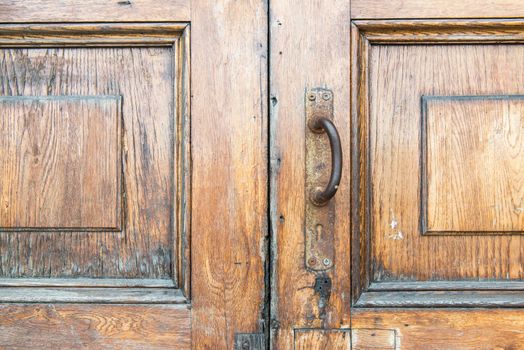 Old vintage rusty wooden door handle taken outdoor in Russia on a sunny day