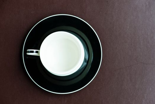 Cup of coffee on a brown mat, can be use for various foods related concept design and background.