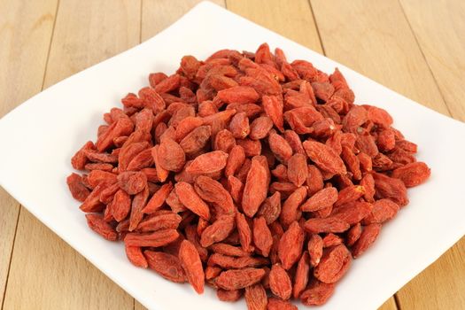 bunch of goji berries on a white plate