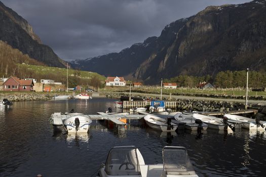 small harbor with mountains in background - evening scene