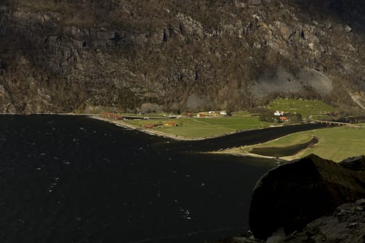 small, deep fjord in norway in changeful weather with cloudy sky