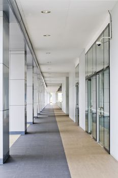 Passageway leading to a multi-level building parking lot.