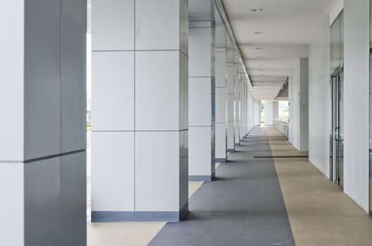 Passageway leading to a multi-level building parking lot.