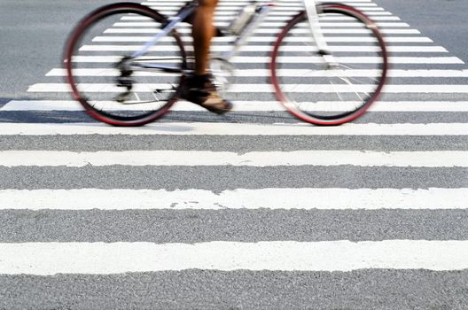 Blur of cyclist in motion on pedestrain lane