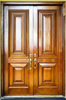 Close-up of heavy wooden door with simple design