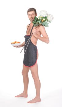 Fun image of an implied naked man clad only in a short apron bearing Valentines or anniversary gifts of a bowl of freshly baked cookies and a bunch of long stemmed flowers isolated on white
