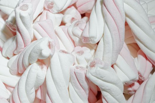 Twisted white and pink marshmallows served at a children's party