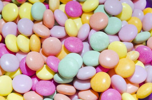 Pastel-colored round candies that look like M&M's served at a children's party