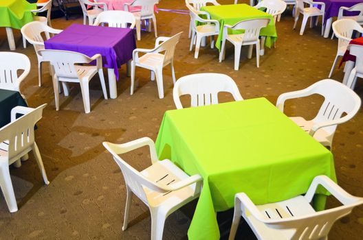 Colorful children's party tables and plastic chairs.