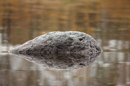 the black meteorite is reflected in water