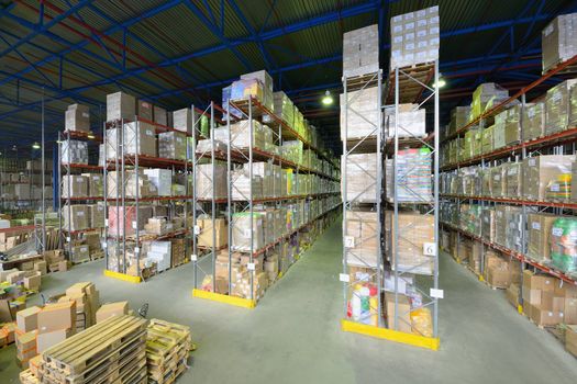 Indoor warehouse with lot of pallet. Wide angle photo.