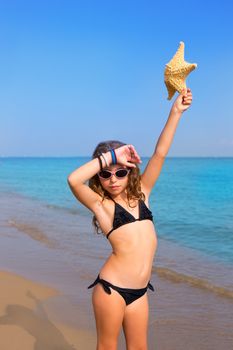 blue beach kid girl with bikini starfish and sunglasses at summer vacations
