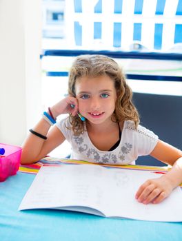 children kid girl smiling with homework in summer holding pencil