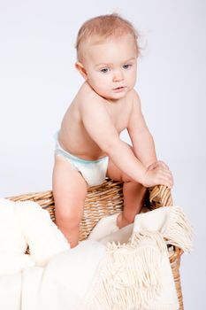 cute little baby infant in basket with white teddy bear