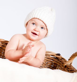 cute little baby infant in basket with white teddy bear