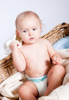 cute little baby infant in basket with white teddy bear
