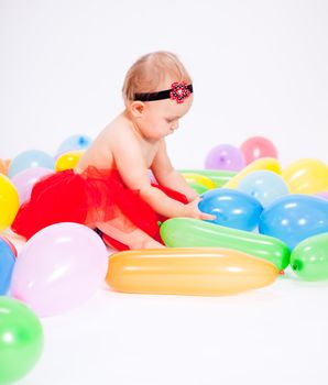 cute little baby child with colorfull balloons birthday celebration