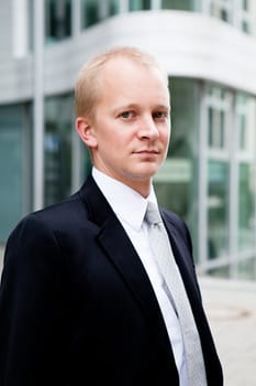 succsessful business man with tie and black dress reading newspaper