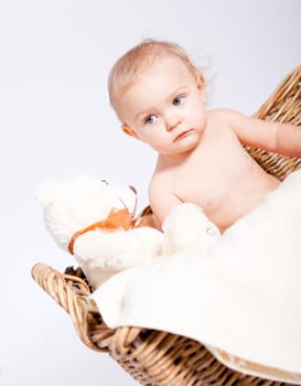 cute little baby infant in basket with white teddy bear