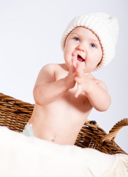 cute little baby infant in basket with white teddy bear