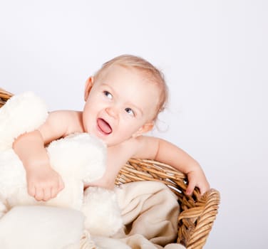 cute little baby infant in basket with white teddy bear