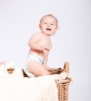 cute little baby infant in basket with white teddy bear