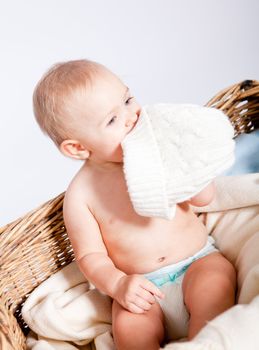 cute little baby infant in basket with white teddy bear