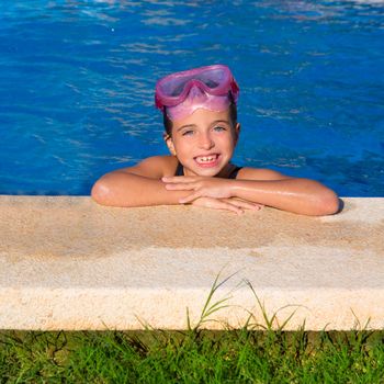 Blue eye kid girl on on blue pool poolside smiling with snorkel glasses