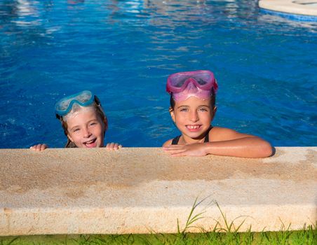 Blue eyes children girls on on blue pool poolside smiling with snorkel glasses