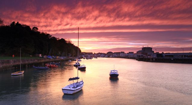 Entrance to weymouth harbour at dusk in southern england